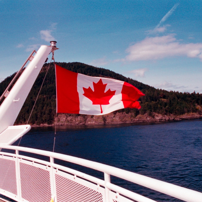 Canada Flag Waving From A Boat Near Vancouver Island